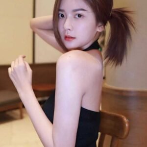 Attractive young woman with brown hair styled in a ponytail, wearing a black halter top.