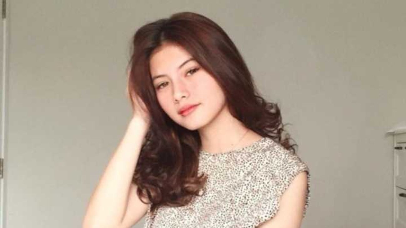 Young woman in a beige dress