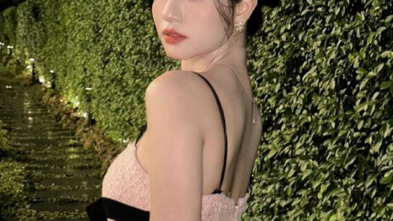 Woman in pink dress looking over shoulder