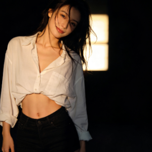 Attractive woman in unbuttoned shirt and shorts. Focus on her physique.