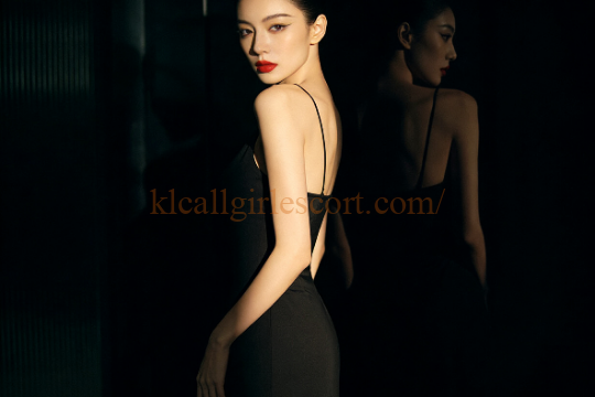 Elegant woman in black dress, red lipstick. KL Escort style.